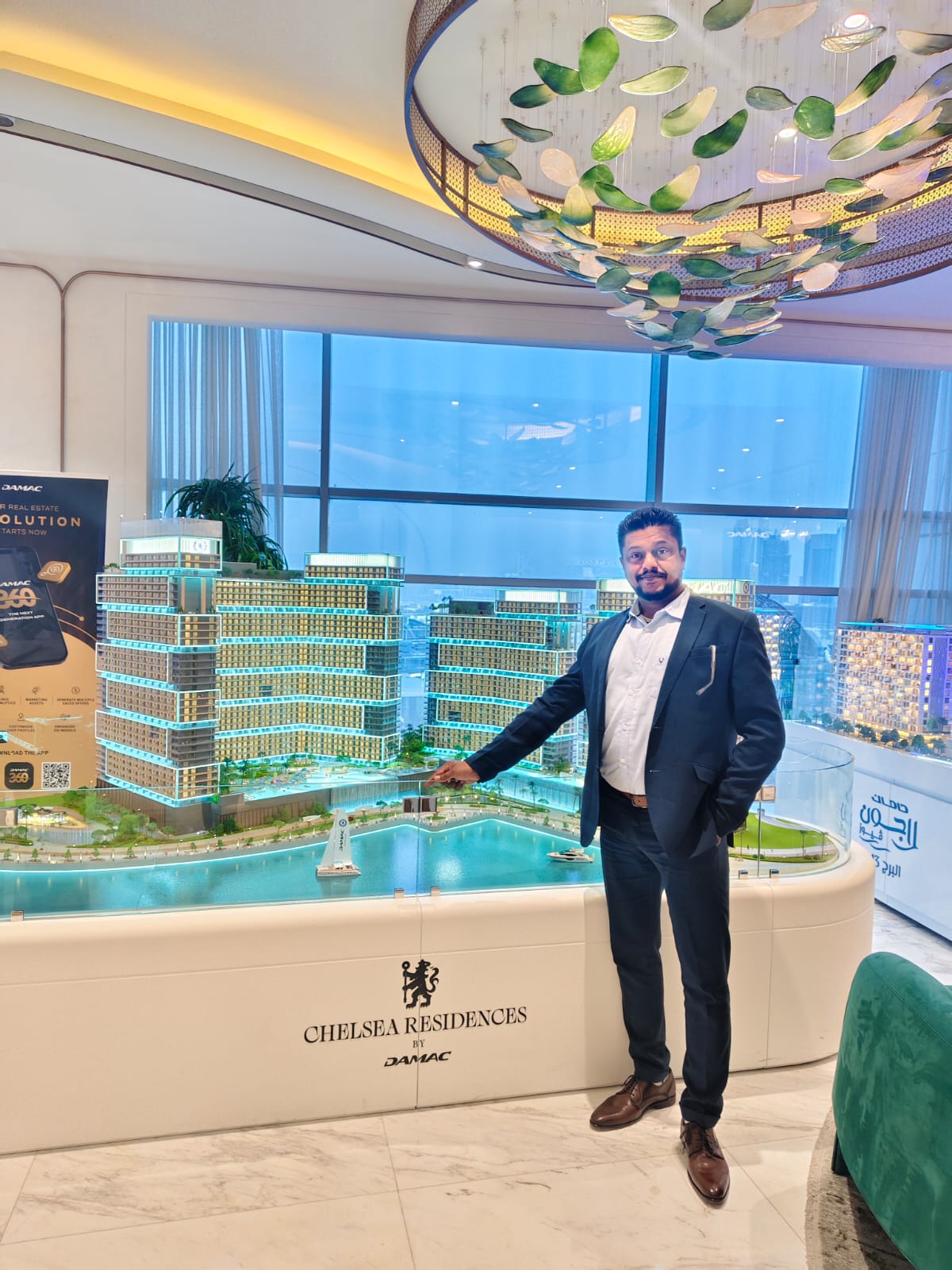 Sandeep Kumar reviewing the Chelsea Residences by DAMAC scale model
